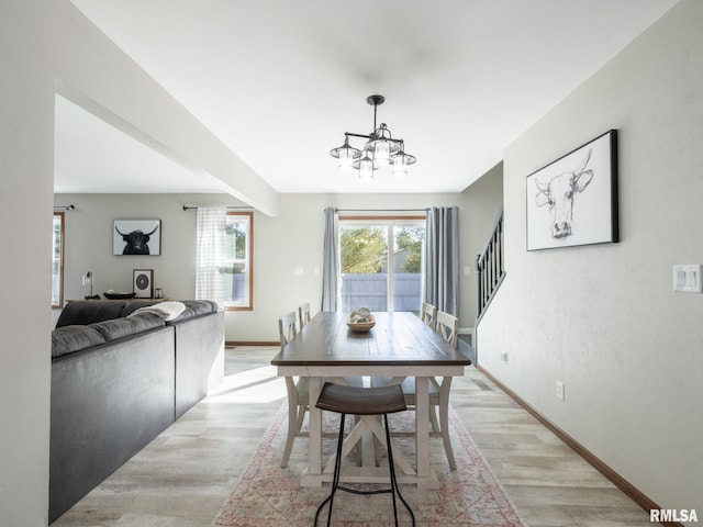 dining room with an inviting chandelier and light wood-type flooring