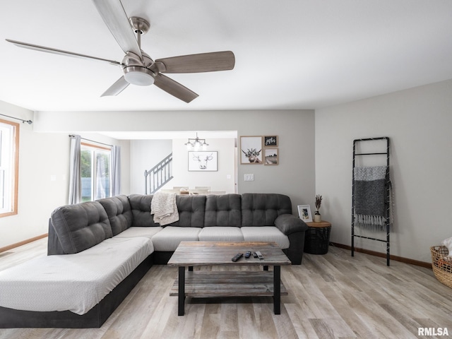 living room with ceiling fan and light hardwood / wood-style flooring