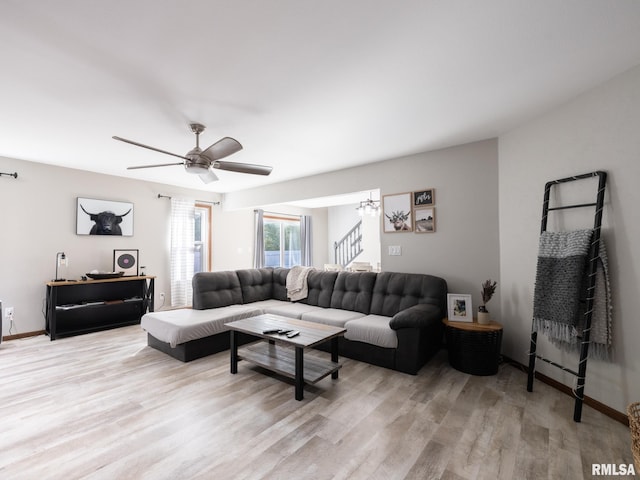 living room with ceiling fan and light hardwood / wood-style floors