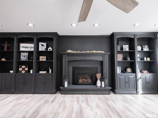 living room with ceiling fan and light wood-type flooring