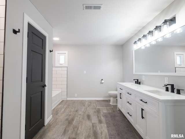 bathroom with vanity, hardwood / wood-style flooring, and toilet