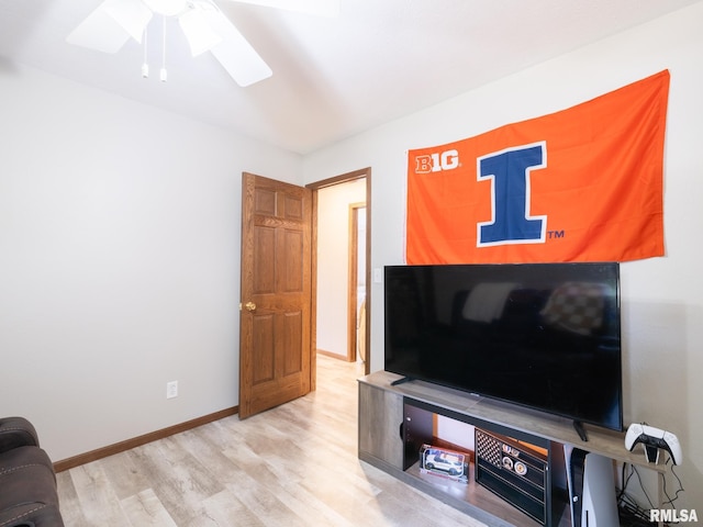 living room with ceiling fan and light hardwood / wood-style flooring