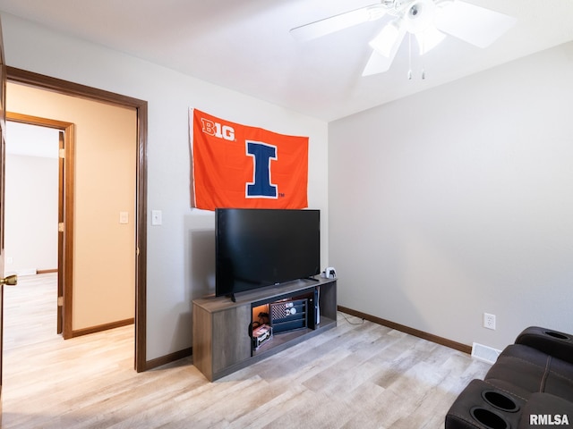 living room with ceiling fan and light hardwood / wood-style floors