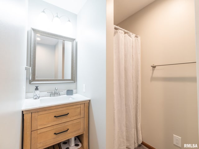 bathroom featuring vanity and curtained shower