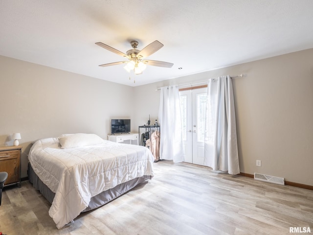 bedroom featuring french doors, ceiling fan, and light hardwood / wood-style floors