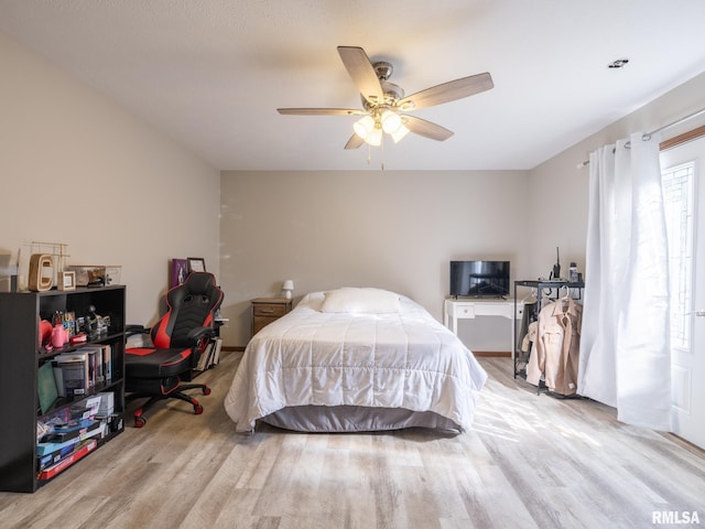 bedroom with ceiling fan and light hardwood / wood-style flooring