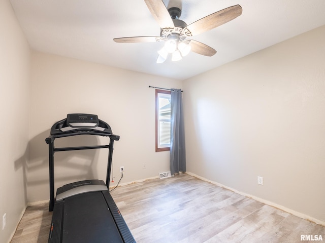 exercise room featuring ceiling fan and light wood-type flooring