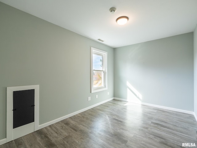 spare room with wood-type flooring