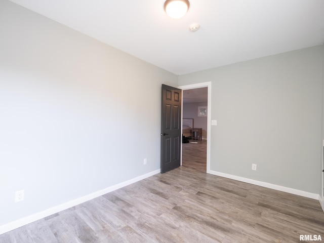 unfurnished room with light wood-type flooring