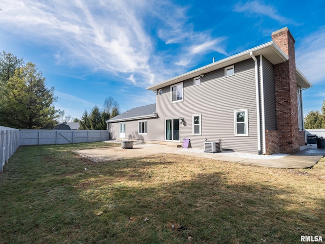 back of house with a yard, central AC unit, and a patio