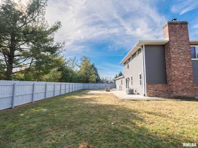 view of yard featuring cooling unit and a patio area