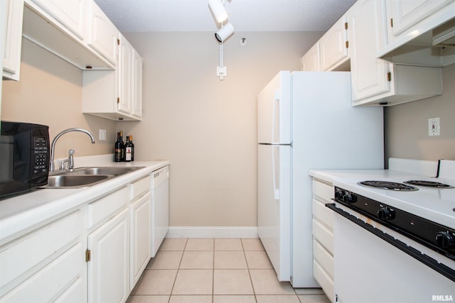 kitchen featuring white appliances, light tile patterned floors, sink, and white cabinets