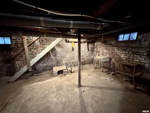 basement with brick wall