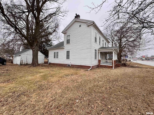 view of side of property featuring a yard and a porch