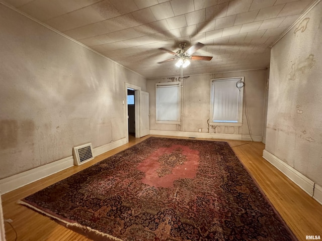 unfurnished room featuring light hardwood / wood-style flooring, ornamental molding, and ceiling fan