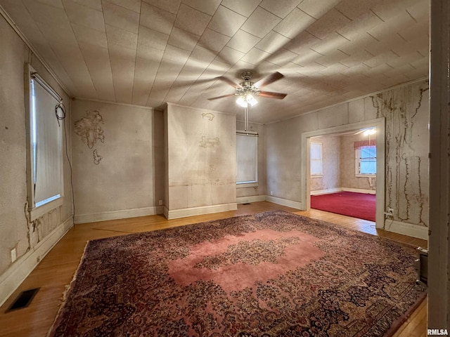 unfurnished room with wood-type flooring and ceiling fan