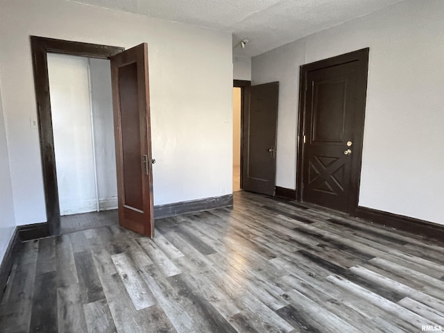 unfurnished bedroom featuring wood-type flooring and a textured ceiling