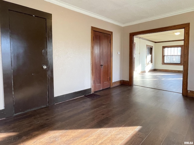 unfurnished room featuring ornamental molding and dark hardwood / wood-style floors