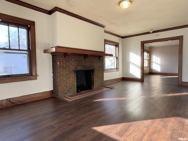 unfurnished living room featuring crown molding, plenty of natural light, and dark hardwood / wood-style floors