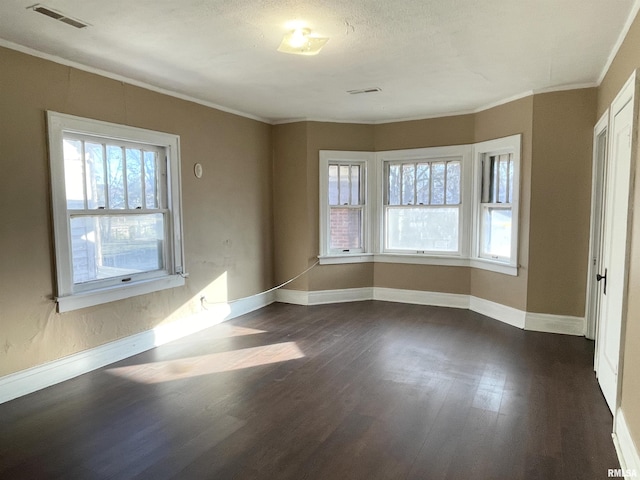 unfurnished room featuring crown molding and dark wood-type flooring