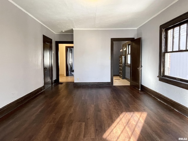 unfurnished room with dark wood-type flooring and ornamental molding