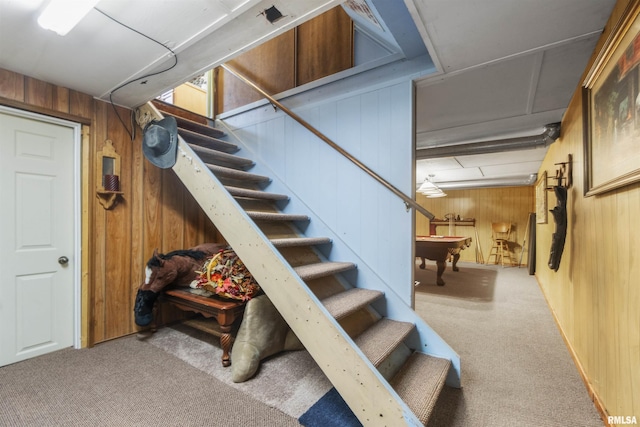 stairs featuring pool table, wooden walls, and carpet flooring