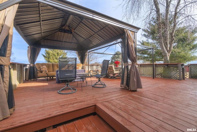 wooden deck with a gazebo and an outdoor hangout area