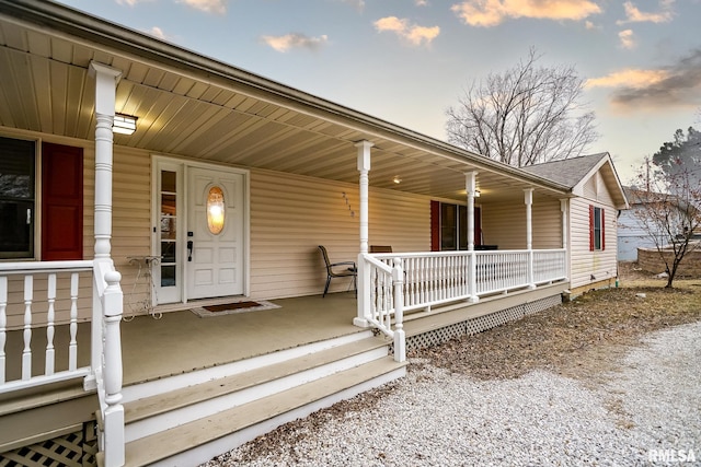 exterior entry at dusk with covered porch