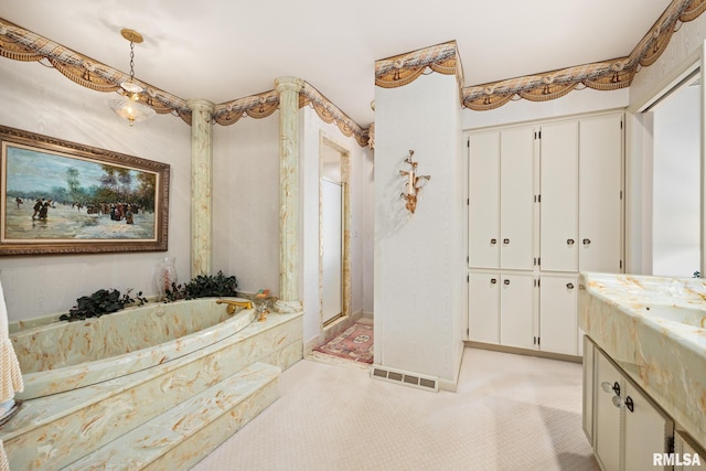 bathroom with vanity and tiled tub