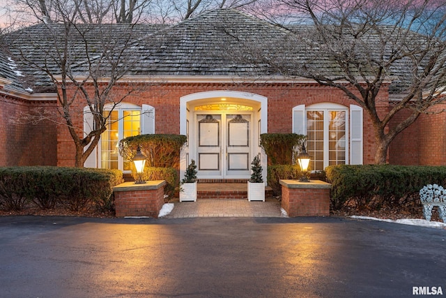 view of exterior entry at dusk