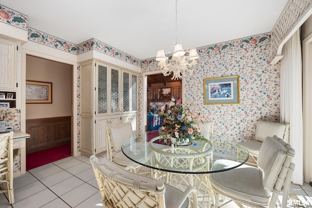 dining area with a chandelier and light tile patterned flooring