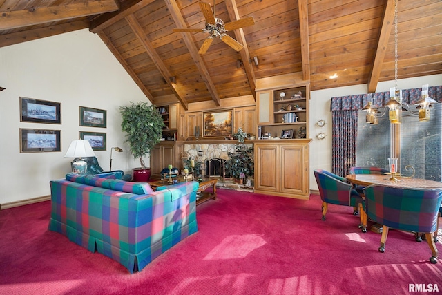 living room featuring dark colored carpet, a stone fireplace, ceiling fan, and beam ceiling