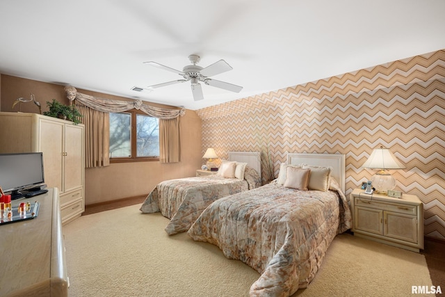 bedroom featuring ceiling fan and light carpet