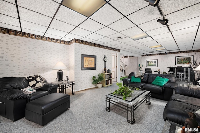 carpeted living room with a paneled ceiling