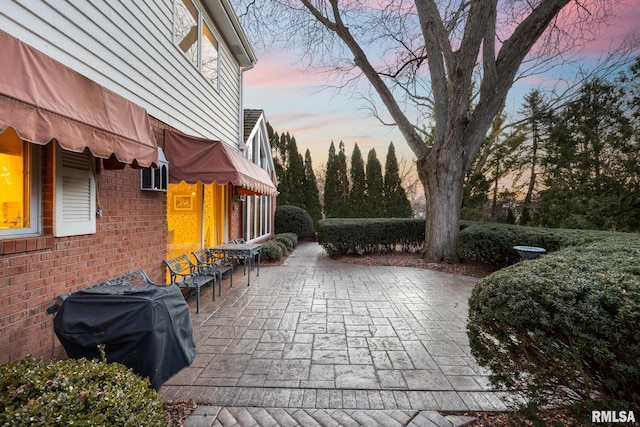 patio terrace at dusk with a grill