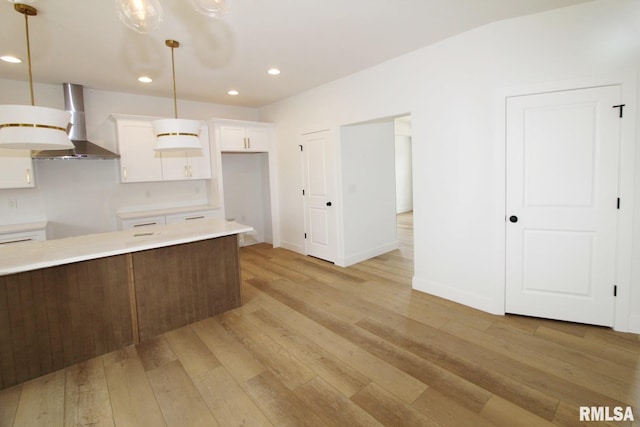 7023 N Water Oak Dr, Edwards, IL 61528 - kitchen with wall chimney range hood, white cabinets, recessed lighting, light wood-style flooring, and light countertops