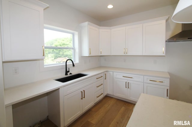 7023 N Water Oak Dr, Edwards, IL 61528 - kitchen featuring a sink, wall chimney exhaust hood, white cabinets, wood finished floors, and recessed lighting