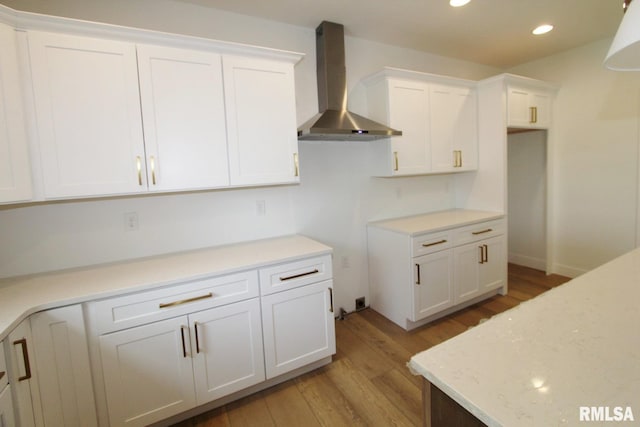 7023 N Water Oak Dr, Edwards, IL 61528 - kitchen featuring wall chimney exhaust hood, light wood-style flooring, recessed lighting, white cabinetry, and light stone counters