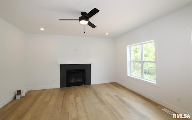 7023 N Water Oak Dr, Edwards, IL 61528 - unfurnished living room featuring a fireplace, light wood-type flooring, ceiling fan, baseboards, and recessed lighting
