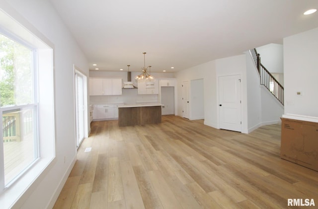 7023 N Water Oak Dr, Edwards, IL 61528 - unfurnished living room with a chandelier, light wood-type flooring, recessed lighting, baseboards, and stairway