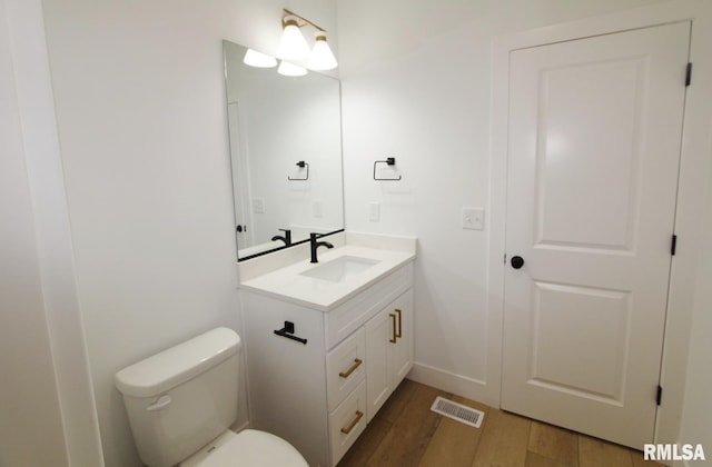 7023 N Water Oak Dr, Edwards, IL 61528 - bathroom featuring vanity, toilet, wood finished floors, and baseboards