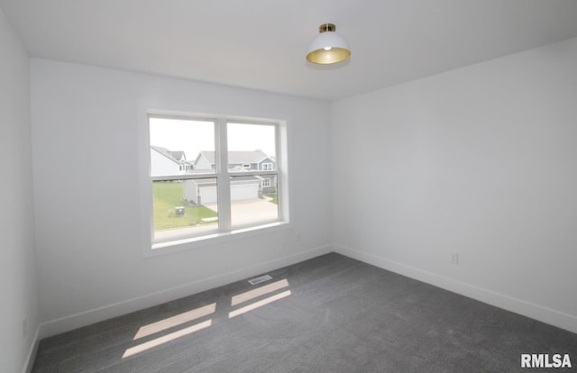 7023 N Water Oak Dr, Edwards, IL 61528 - spare room with baseboards and dark carpet