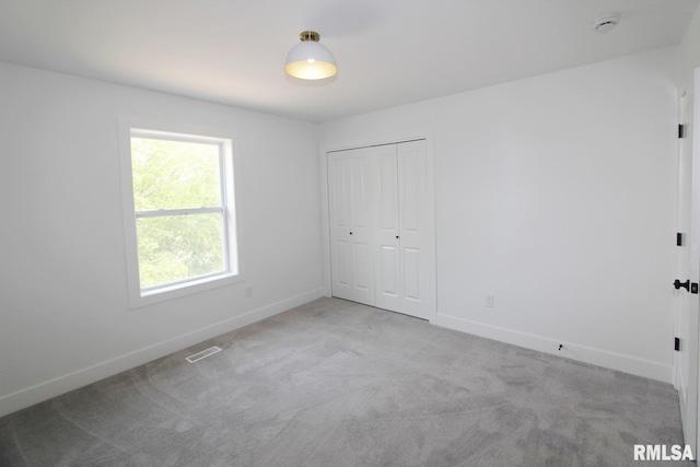 7023 N Water Oak Dr, Edwards, IL 61528 - unfurnished bedroom with baseboards, carpet floors, and a closet