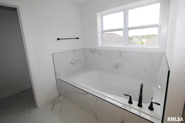7023 N Water Oak Dr, Edwards, IL 61528 - bathroom featuring marble finish flooring, baseboards, and a bath