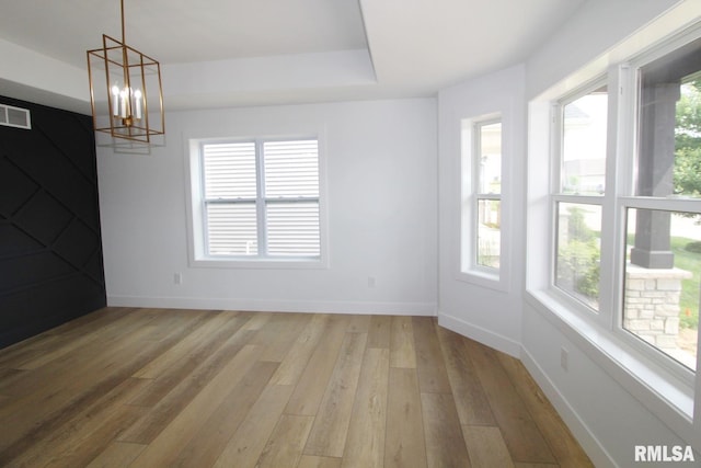 7023 N Water Oak Dr, Edwards, IL 61528 - spare room with healthy amount of natural light, light wood finished floors, a chandelier, and baseboards