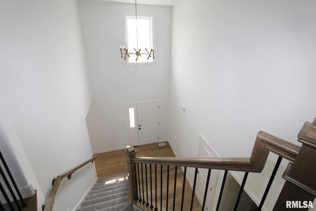 7023 N Water Oak Dr, Edwards, IL 61528 - stairs featuring wood finished floors, baseboards, and a chandelier