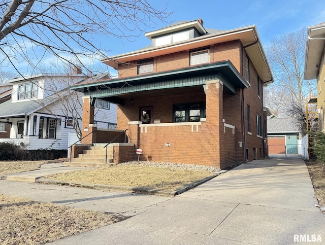 view of front of house featuring an outbuilding, a garage, and covered porch