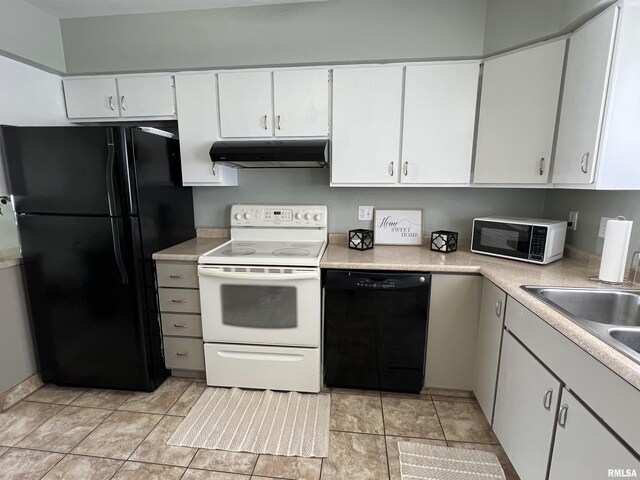 kitchen featuring white cabinets, light tile patterned floors, ceiling fan, black appliances, and washer and clothes dryer