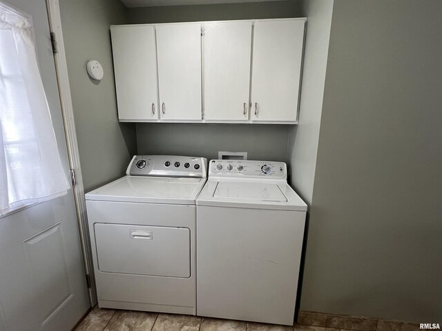 clothes washing area featuring cabinets and independent washer and dryer