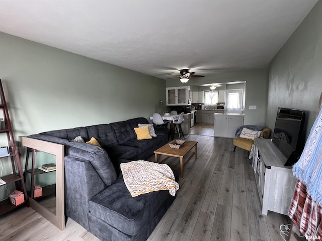 living room with wood-type flooring and ceiling fan